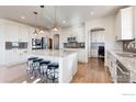 Gourmet kitchen with a granite countertops, an island, and stainless steel appliances at 18690 W 84Th Dr, Arvada, CO 80007