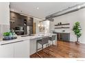 Modern kitchen with stainless steel appliances, marble countertops, a wine fridge, and hardwood floors at 2030 20Th St # 7, Boulder, CO 80302