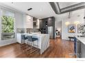 Spacious kitchen with marble countertop island, stainless steel appliances, and hardwood floors at 2030 20Th St # 7, Boulder, CO 80302