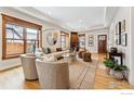 Elegant living room with hardwood floors, a cozy fireplace, and large windows providing plenty of natural light at 2137 Mapleton Ave, Boulder, CO 80304