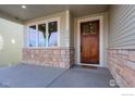 Charming home featuring a wooden front door, stone accents, and a welcoming covered porch at 2397 Bristol St, Superior, CO 80027