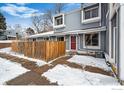 Charming townhome with a red front door and a well-maintained exterior, perfect for winter at 2557 S Dover St # 30, Lakewood, CO 80227