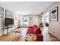 Spacious living room featuring hardwood floors, a comfortable sofa, and natural light at 2557 S Dover St # 30, Lakewood, CO 80227