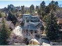 Aerial view of a modern home surrounded by trees and nature with a long driveway and multi-car parking at 2690 Juilliard St, Boulder, CO 80305