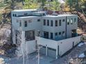 Stunning three-story home featuring a unique architectural design, neutral color palette, and two-car garage at 2690 Juilliard St, Boulder, CO 80305