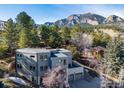 Contemporary gray home featuring mountain views, mature trees, and a two-car garage at 2690 Juilliard St, Boulder, CO 80305