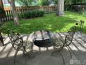 Backyard with mature trees, a well-maintained lawn, a fire pit, and sitting area perfect for outdoor relaxation at 3349 Sentinel Dr, Boulder, CO 80301