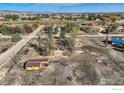 Sprawling property aerial view with a home, barn, fenced in area and mountain views at 4025 Arleigh Dr, Berthoud, CO 80513