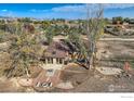 An aerial view of an outdoor patio and yard, perfect for entertaining with a fire pit at 4025 Arleigh Dr, Berthoud, CO 80513