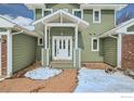 Inviting entryway featuring a brick path leading to the covered front porch at 4869 Kellogg Cir, Boulder, CO 80303