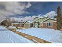 Residential street with a view of a charming two-story home with green siding at 4869 Kellogg Cir, Boulder, CO 80303