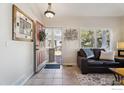 Inviting foyer with tile flooring, an open doorway and a leather sofa at 5019 Pasadena Way, Broomfield, CO 80023