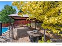 Backyard deck including a cabana, fire pit, and decorative rope railing at 560 S 9Th St, Berthoud, CO 80513