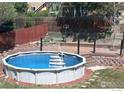 Above-ground backyard pool with deck and privacy fence at 560 S 9Th St, Berthoud, CO 80513