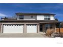 Charming two-story home showcasing a brick facade and three-car garage, offering ample space and curb appeal at 560 S 9Th St, Berthoud, CO 80513