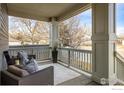 Inviting front porch with comfortable seating, decorative pillows, and a view of the neighborhood at 722 Hutchinson St, Louisville, CO 80027