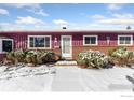 The front of the house features well-maintained bushes and a classic brick and wood exterior at 805 38Th St, Boulder, CO 80303