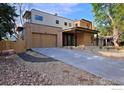 Contemporary home featuring a concrete driveway, well-manicured landscaping, and a spacious two-car garage at 864 Iris Ave, Boulder, CO 80304