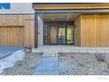 Stunning entryway with wood accents, a modern door and rock landscaping at 864 Iris Ave, Boulder, CO 80304