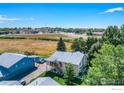 An aerial view showcases the property's location near local roads and green space at 1057 W 112Th Ave # D, Denver, CO 80234