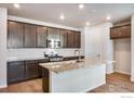 Modern kitchen featuring granite countertops, stainless steel appliances, and hardwood floors at 1419 Great Western Dr, Longmont, CO 80501