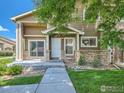 Charming home featuring well-maintained landscaping, a covered entryway, and a concrete walkway at 1601 Great Western Dr # 3, Longmont, CO 80501