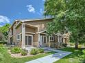 Inviting townhome featuring a beautiful exterior with a manicured lawn and mature trees at 1601 Great Western Dr # 3, Longmont, CO 80501