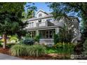 Charming home featuring a covered front porch and second story balconies surrounded by lush landscaping at 1601 Redwood Ave, Boulder, CO 80304