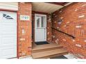 Close-up of front door featuring brick facade and welcoming entryway at 1737 Grove Ct, Longmont, CO 80501