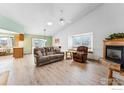 Bright and airy living room with fireplace, vaulted ceiling, and ample natural light at 1737 Grove Ct, Longmont, CO 80501