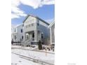 Charming two-story home with a gray facade, inviting front porch, and well-maintained front yard at 182 Sassafras St, Erie, CO 80516