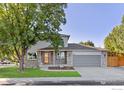 Charming two-story home boasts a manicured front yard and a two-car garage at 2437 Maplewood E Cir, Longmont, CO 80503