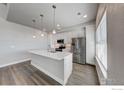 Bright kitchen features stainless steel appliances, a large island, and modern lighting at 265 High Point Dr # 201, Longmont, CO 80504