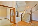 Spacious foyer with hardwood floors and an elegant staircase at 288 Dover Ct, Broomfield, CO 80020