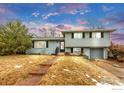 Two-story home with a blue sky and green grass at 4493 Hamilton Ct, Boulder, CO 80305