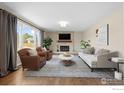 Cozy living room features a stone fireplace, large window, and comfortable seating at 5003 Forsythe Pl, Boulder, CO 80303