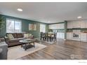 Bright and airy living room featuring a modern design, seamlessly connecting to the dining and kitchen areas at 9416 Lamar St, Westminster, CO 80031