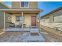 Attractive home showcasing a welcoming front porch and manicured landscaping with decorative rocks at 1117 Hummingbird Cir, Longmont, CO 80501