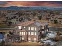 An aerial view of the rear of the property showcasing a patio and mountain views at 13964 Beacon St, Broomfield, CO 80023