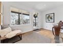 Bright entryway featuring hardwood floors, a bench, and a large window that offers a welcoming view of the neighborhood at 2122 Goss Cir, Boulder, CO 80302
