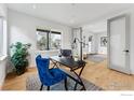 Comfortable home office with hardwood floors, a blue chair, natural light, and an open view to other rooms at 2122 Goss Cir, Boulder, CO 80302