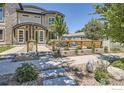 Attractive home exterior with modern landscaping, a well-manicured lawn, and a welcoming entrance with stone accents and fresh plantings at 2235 Cherokee St, Denver, CO 80223