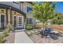 Charming home exterior featuring stone accents, an inviting front door, and a beautifully landscaped front yard with mature tree at 2235 Cherokee St, Denver, CO 80223