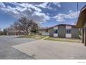 Spacious home exterior with a large, paved driveway and well-maintained landscaping at 3380 County Road 38, Mead, CO 80542
