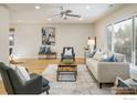 Bright living room features hardwood floors, plush seating, and a ceiling fan at 4470 W Lakeridge Rd, Denver, CO 80219