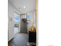 Warm foyer featuring a decorated door and a console table with decorative accents at 509 Brennan Cir, Erie, CO 80516