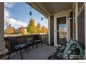 Inviting outdoor porch with comfortable seating and decorative hanging lights at 509 Brennan Cir, Erie, CO 80516