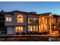 Elegant home with large windows and an inviting entrance under a clear sky at 5799 Crestbrook Cir, Morrison, CO 80465