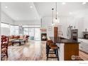 Open-concept living room features a fireplace, kitchen island, and seating area at 751 W Grange Ct # A, Longmont, CO 80503