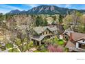 Stunning exterior of home with lush landscaping and Flatiron mountains in the background at 851 14Th St, Boulder, CO 80302